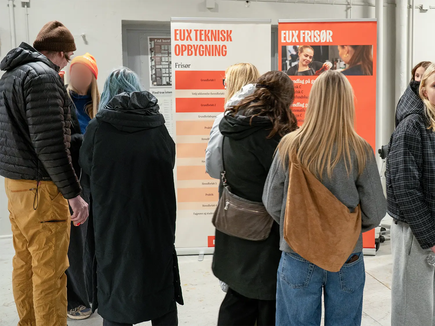 People surrounding the education roll-ups at the event